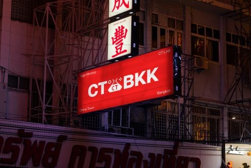 Red horizontal sign mockup showing CT BKK logo on urban building facade at dusk