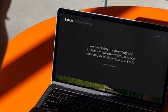 Laptop with website mockup on screen for branding agency on orange background, web design template, digital mockup for designers.