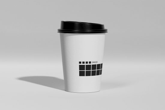 Realistic paper coffee cup mockup with black lid and grayscale checkerboard pattern design, ideal for branding presentations and packaging mockups.