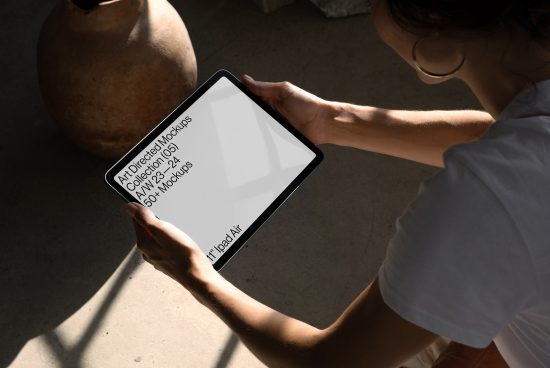 Person holding tablet mockup in sunlight for digital asset design showcasing, perfect for designers' presentations.