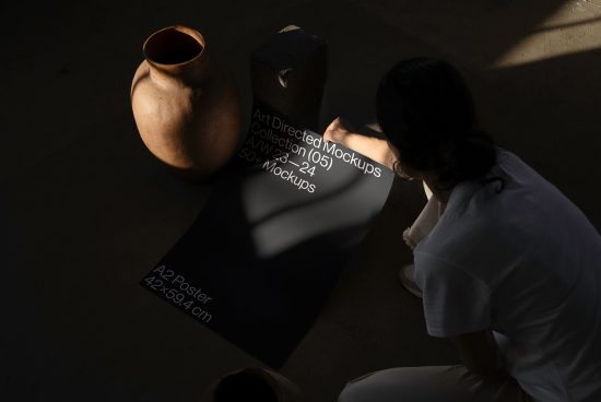 Designer viewing Art Directed Mockups with clay pot and concrete shapes, dynamic shadows, A2 poster mockup visible.