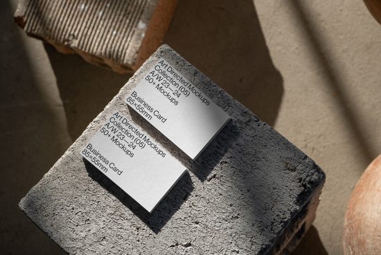 Business card mockup on textured stone surface in natural light, ideal for presenting branding designs to clients, featuring multi-angle views.