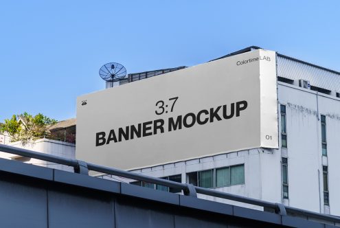 Outdoor billboard banner mockup on a building facade with clear skies, ideal for realistic advertising and urban design presentations.