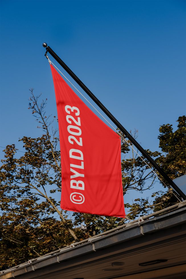 Flag mockup with red banner design and clear sky for graphic designers, perfect for branding presentations and design assets.