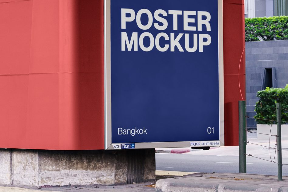 Navy blue poster mounted between red walls with white text visible, bordered pillars