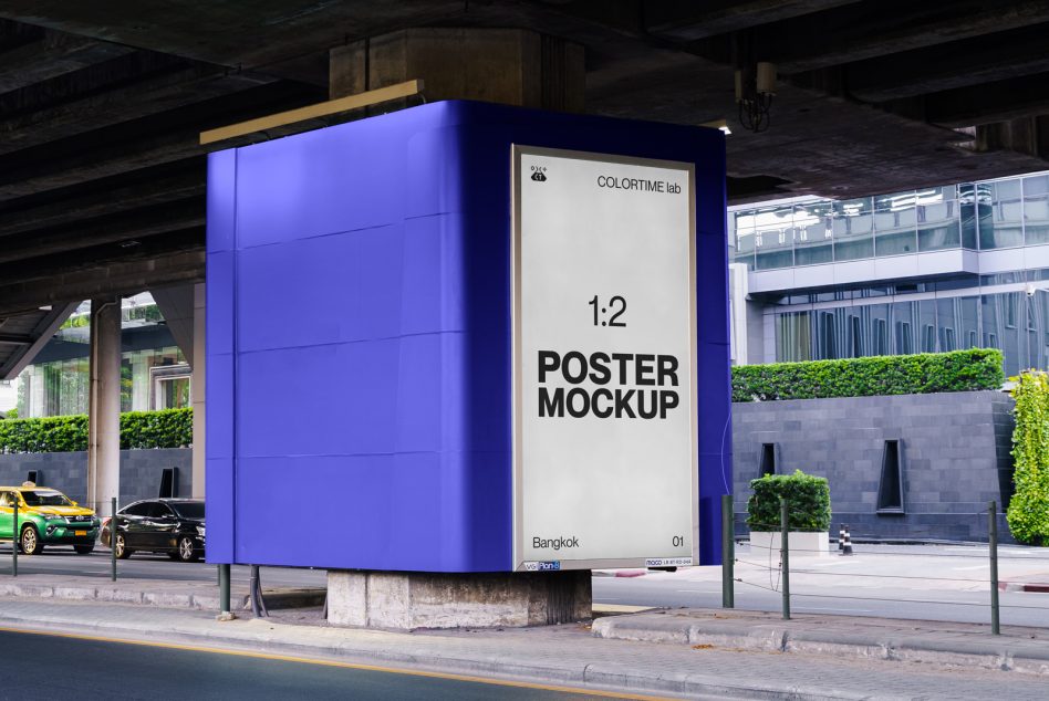 Tall 1:2 vertical poster on bright blue pillar under underpass with living plants nearby