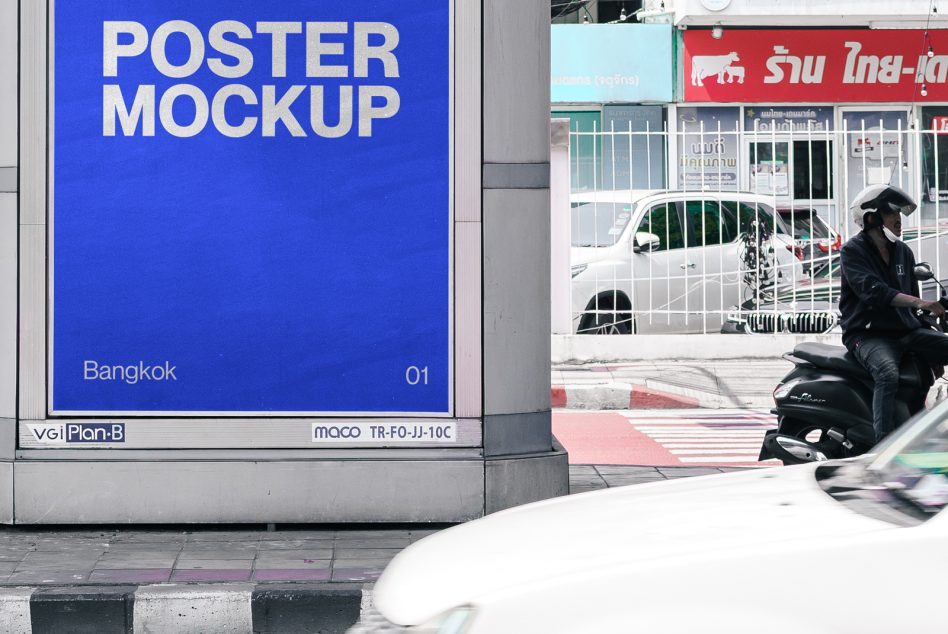 Outdoor billboard poster mockup on a city street with passing vehicles and a motorcyclist, ideal for graphic design presentations.