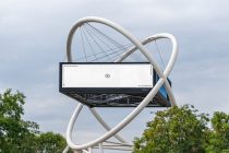 Digital billboard on white sculptural structure with cable-stayed design