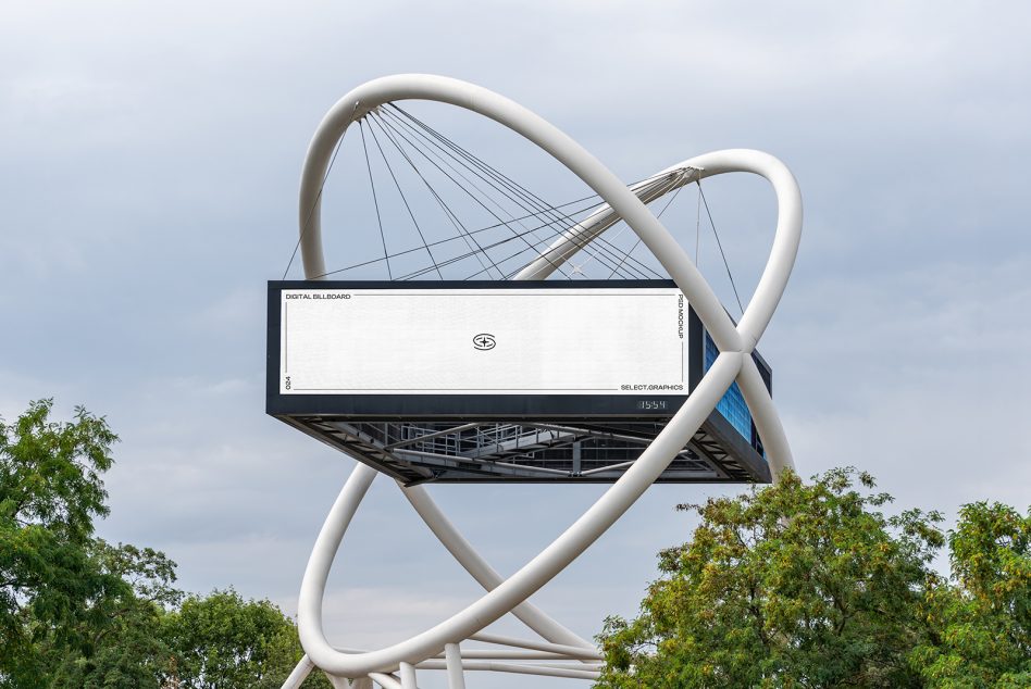 Outdoor digital billboard mockup in a modern urban setting with clear sky and trees for advertising and graphic design display.