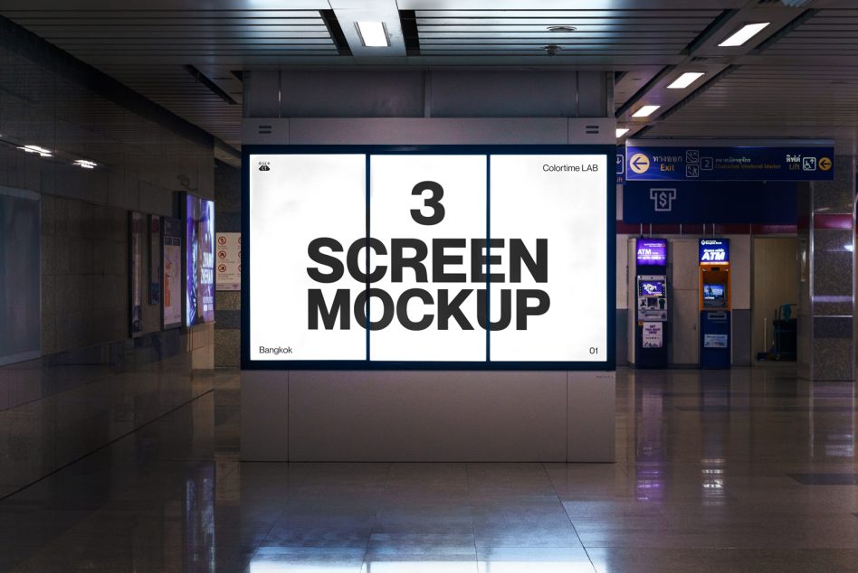 Three-panel white LED screen mounted in transit corridor with black typography