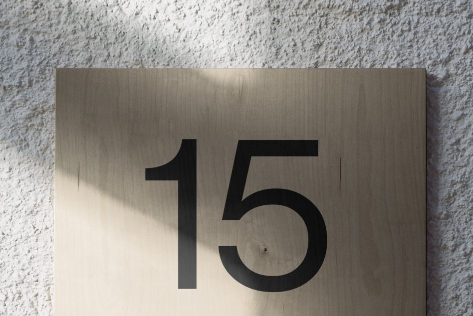 Wooden plate with number 15 in modern font, interesting light and shadow, perfect for mockup or typography design inspiration