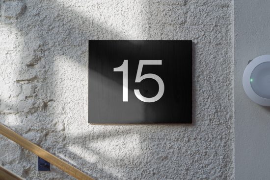 Modern house number 15 sign mockup on textured wall for exterior design presentation, suitable for graphics and templates.