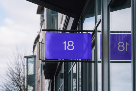Blue signage mockup with numeral 18 displayed on building exterior for graphic designers and branding experts.