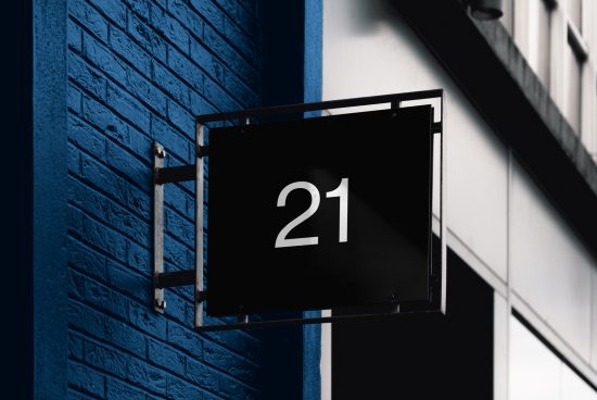 Elegant black signboard with white numerals mockup on a blue brick wall, ideal for designers creating branding or signage presentations.