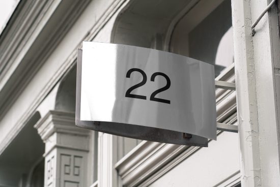 Elegant street sign mockup featuring number 22 on building facade, perfect for showcasing address designs and fonts in urban settings.