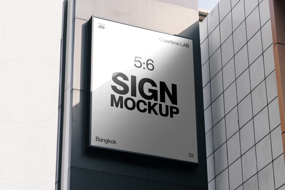 Large white billboard on building corner showing sign mockup in 5:6 ratio