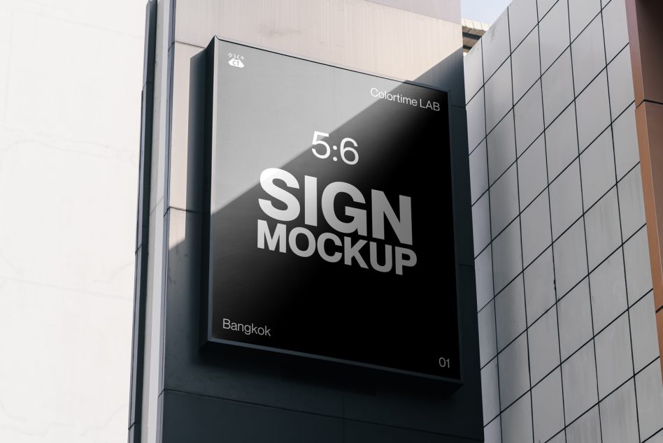 Dark billboard on building corner displaying sign mockup in 5:6 ratio