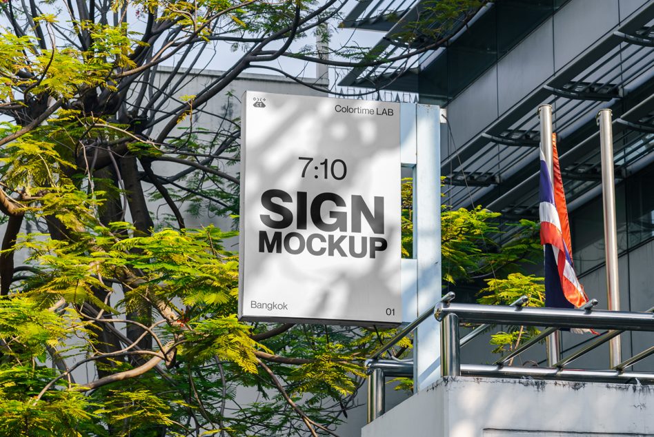 Outdoor sign mockup displayed in urban environment with trees and Thai flag, perfect for graphic designers to showcase branding.