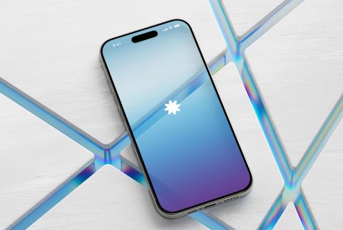 Smartphone mockup on white wooden surface with abstract reflections, sleek design for app presentation, digital asset for graphic designers.