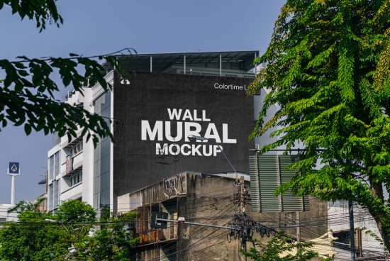 Urban wall mural mockup on a building exterior with green foliage, suitable for graphics and template design previews.