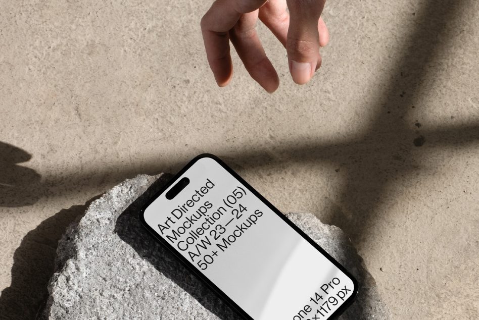 iPhone 14 Pro with white screen mockup on concrete surface outdoors