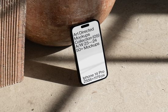 iPhone 14 Pro mockup on textured surface with shadows, promoting Art Directed Mockups Collection for designers, featuring high-resolution display.