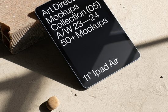 Digital mockup of a 11-inch iPad Air displaying an art direction collection, resting on a concrete surface with a strong shadow. Ideal for design presentations.
