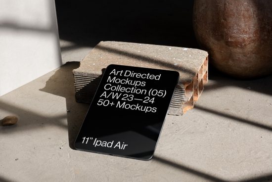 Realistic iPad Air mockup in sunlight, with brick prop and pottery, for digital asset designers, perfect for showcasing app UI/UX designs.