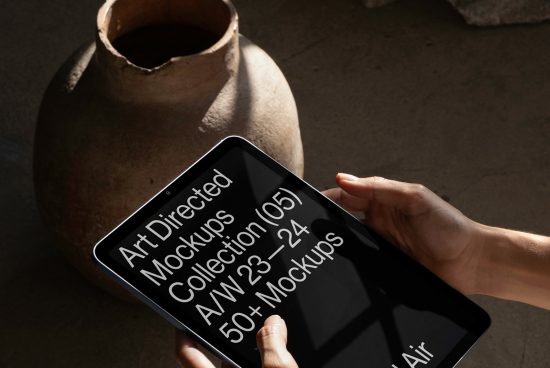Hand holding tablet showcasing mockup collection advertisement, with a rustic clay pot in the background, suitable for graphic designers.