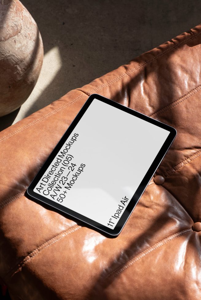 Tablet mockup on a leather surface with text, shadow play, digital device mockup for presenting UI UX designs, ideal for designers and presentations.