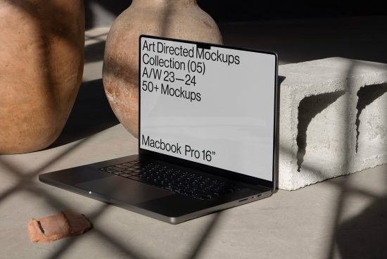 Laptop displaying screen with mockup collection ad, placed on concrete surface beside a clay pot, ideal for design presentation assets.