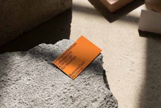 Business card mockup on textured stone, showcasing design presentation capabilities for branding with natural shadows and light.