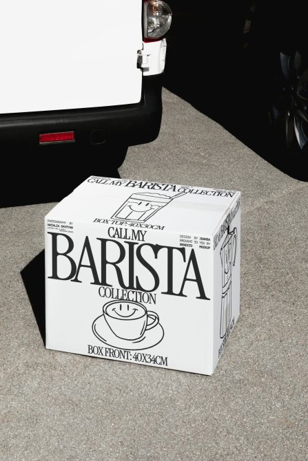 Packaging mockup of a white coffee-themed box with large font and cup design, by a vehicle on urban street, ideal for product presentation.