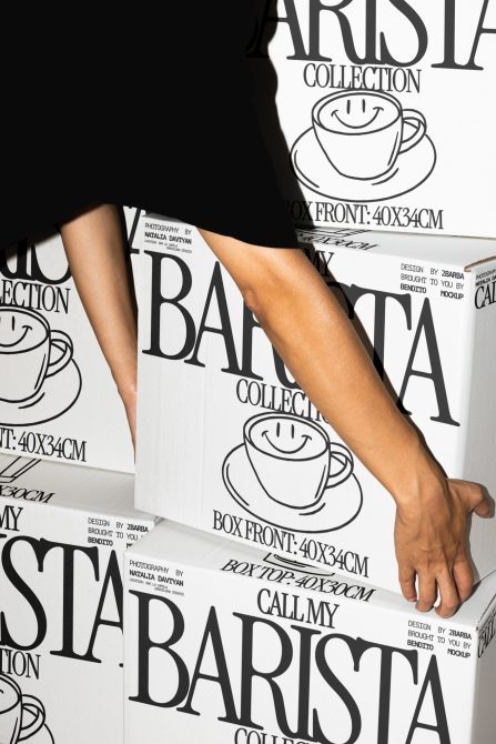 Person interacting with coffee packaging design mockup, featuring large typography and line art cup graphic, ideal for branding presentations.