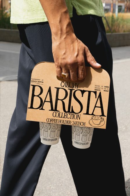 Person holding a cardboard coffee holder mockup with "Barista Collection" design for template showcasing. Perfect for designers' product presentation.