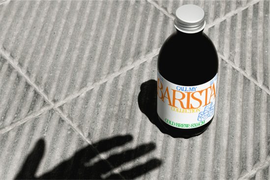 Product mockup showing a cold brew coffee bottle with label on textured background, ideal for beverage packaging design presentations.