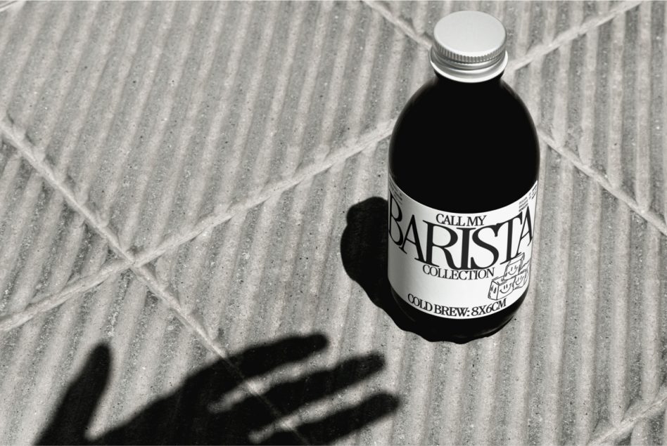 Monochrome Barista Collection bottle sitting on crosshatch tile pattern
