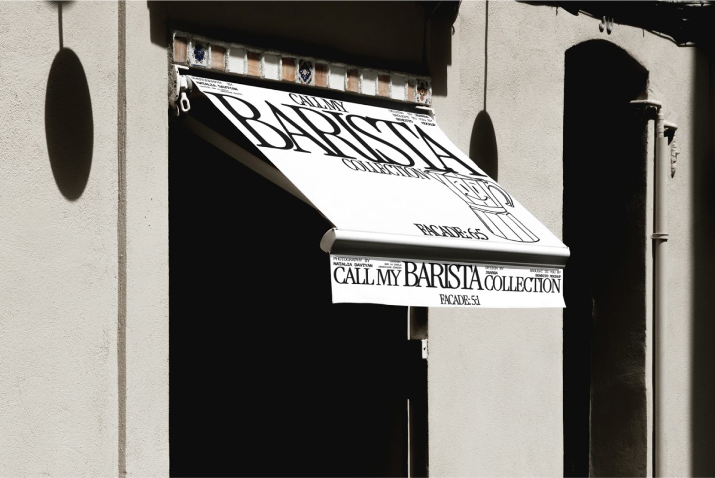 Street view mockup of a retractable store awning featuring stylized 'CALL MY BARISTA COLLECTION' font design, perfect for showcasing signage templates.