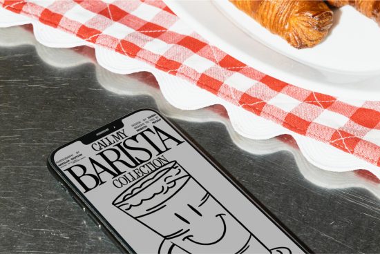 Smartphone screen showcasing barista themed graphic design on a cafe counter with croissant and checkered napkin, ideal for template mockups.