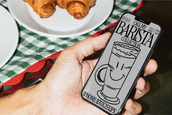 Hand holding smartphone showcasing barista-themed graphic design mockup with croissants and coffee on tabletop, ideal for branding presentations.