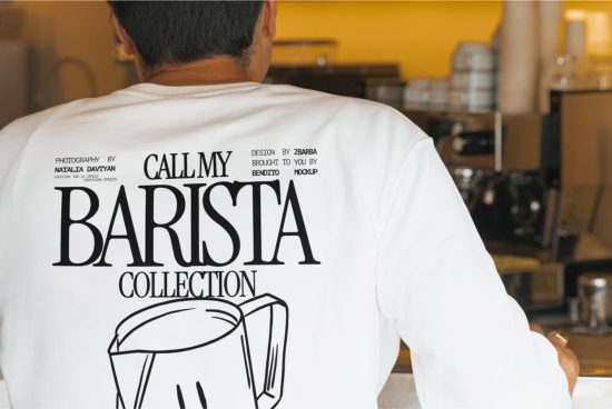 Back view of a person wearing a printed t-shirt mockup with barista thematics, in a coffee shop setting, suitable for apparel design.