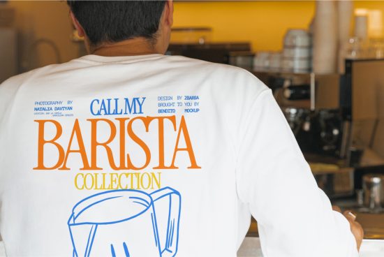 Man in white t-shirt with barista themed graphic design, viewed from behind, suitable for mockup templates in cafe setting.