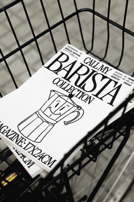 Black and white magazine cover mockup in shopping cart featuring bold typography and line art coffee pot, creative design presentation, high contrast.