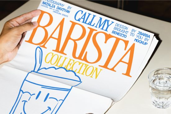 Hand holding a magazine mockup with bold typography design, titled Call My Barista Collection, next to a glass of water on a table.