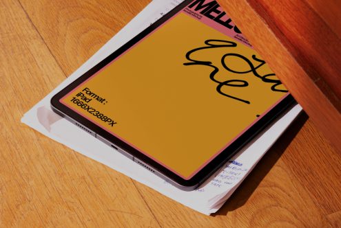 Digital tablet mockup with magazine for presenting app and web designs on a wooden surface, design assets for creatives.