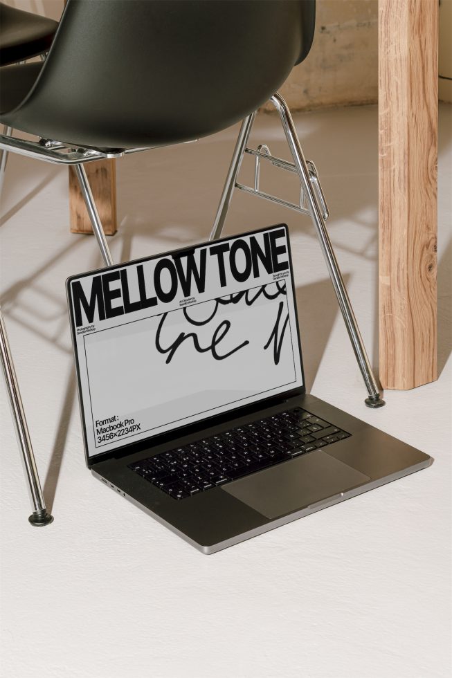 Laptop on desk showcasing bold MELLOWTONE font design mockup for designers, clear and elegant presentation, modern workspace setting.