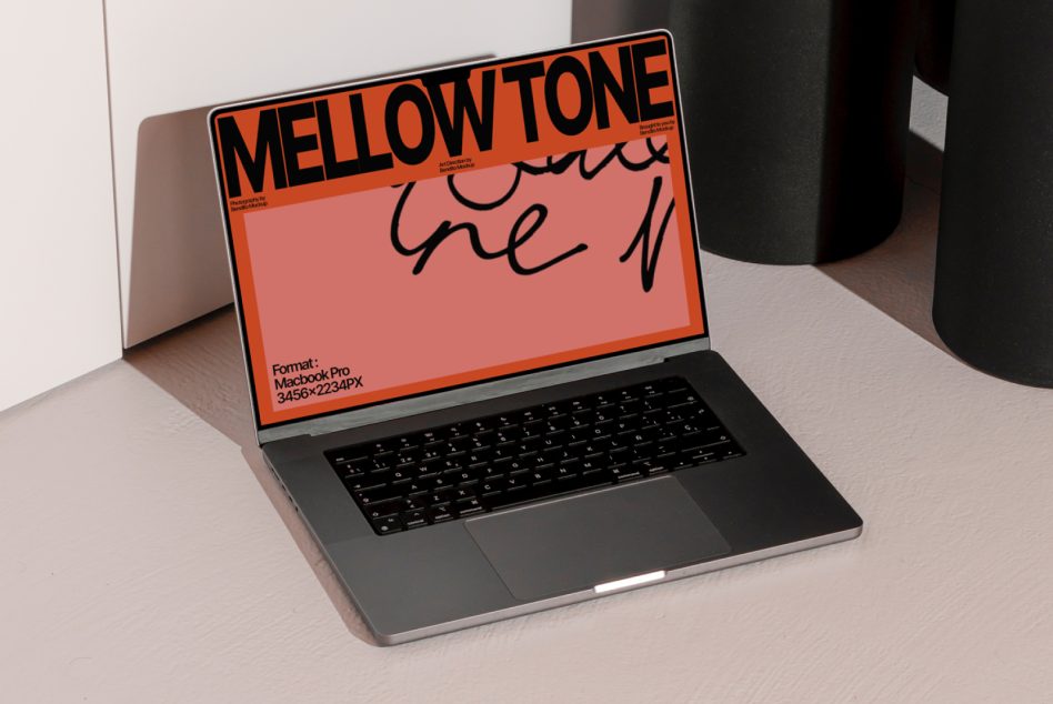 Macbook Pro with Mellow Tone mockup in bright orange, black lettering, handwritten element visible