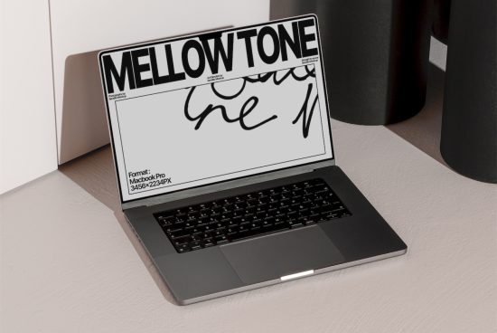 Laptop showcasing font design MELLOWTONE, ideal for graphics category, emphasizing modern typography in a realistic office setting.