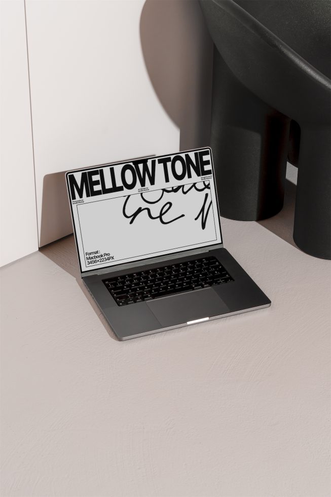 Laptop mockup on desk with stylized font design on screen for digital assets, graphic design, typography presentation, modern workspace setting.