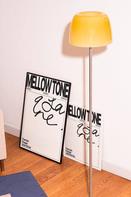 Modern poster mockups leaning against wall with stylish yellow lamp, showcasing script font, perfect for presentations, graphic design assets.